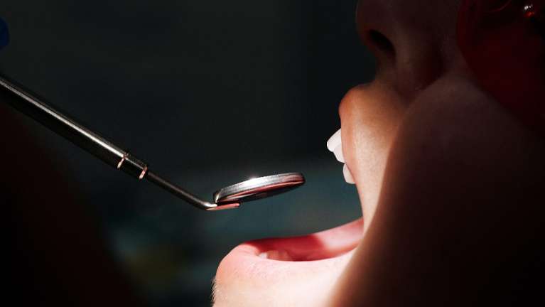 emergency dentist dedham | Woman receiving an oral exam
